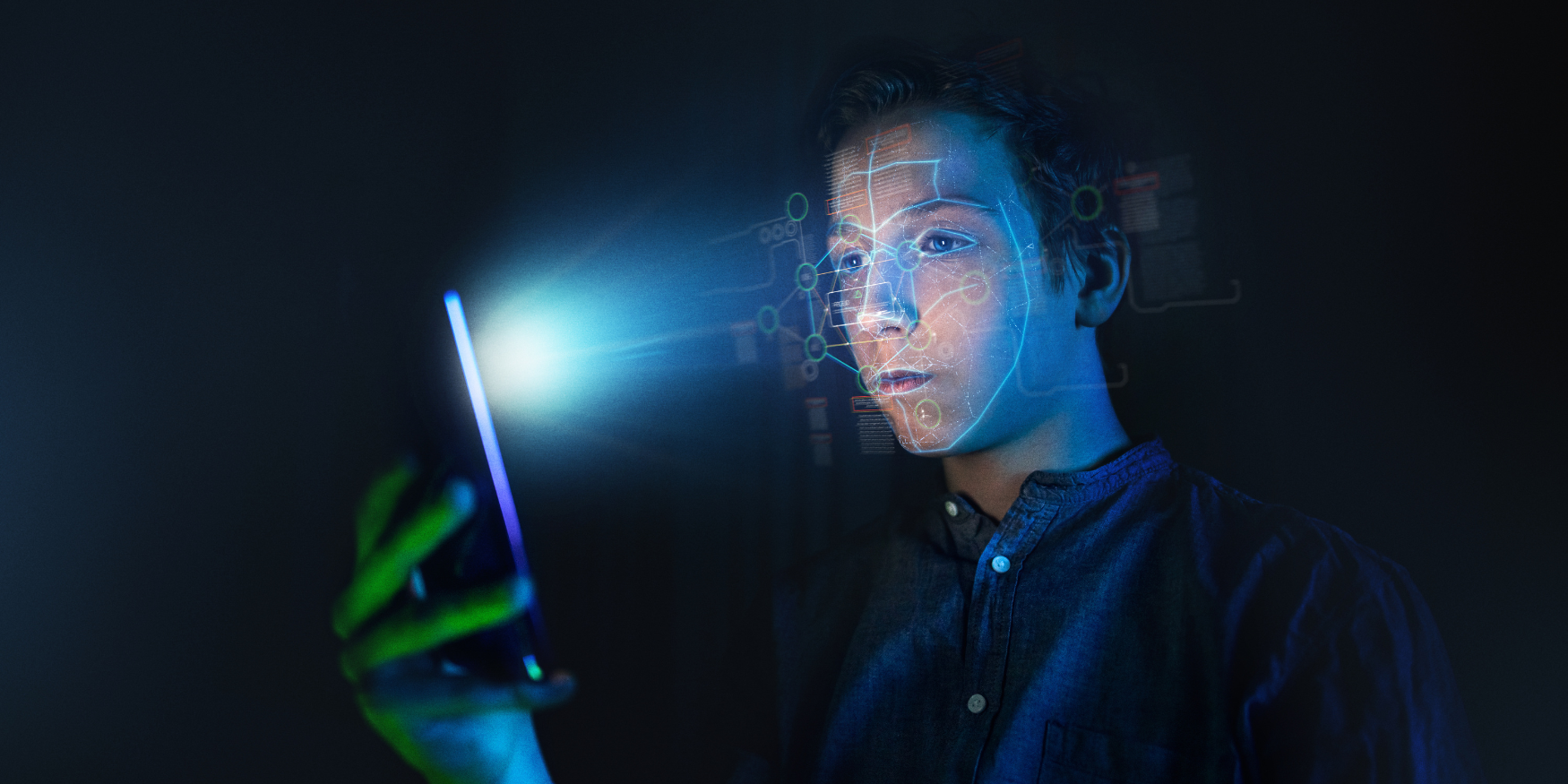 Young man scanning face using liveness detection on cellphone
